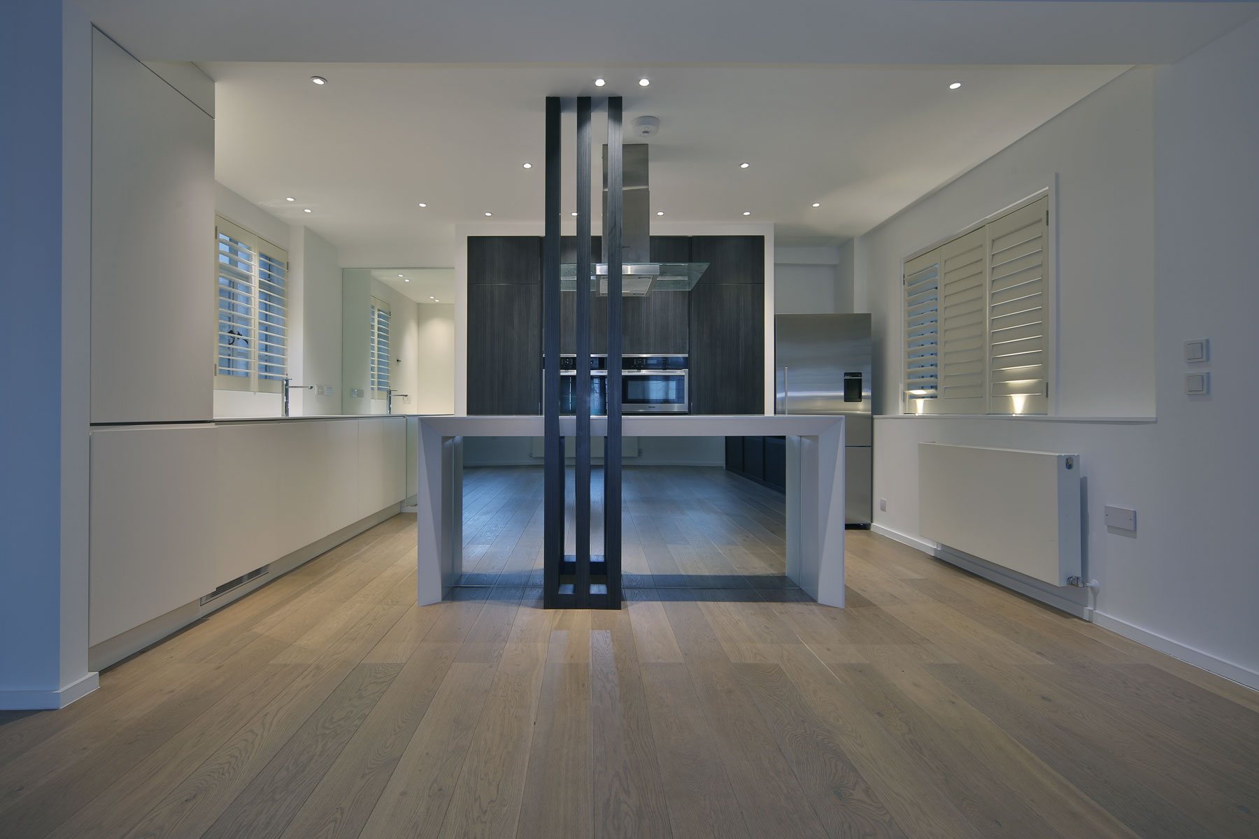 Premium open plan kitchen and dining area showcasing high-end wooden flooring and minimalist architecture by Vanity Pix ( @vanitypix )