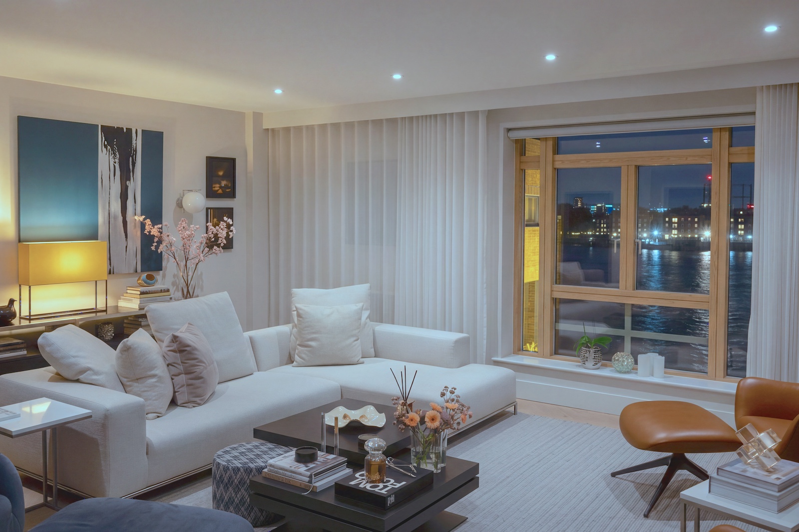 A modern, sophisticated living room interior at night. Photography by Vanity Pix.