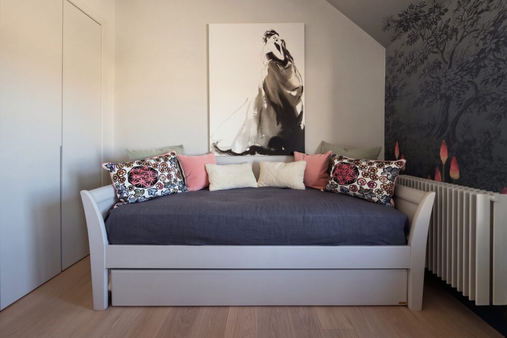 A centered, eye-level shot of a modern daybed in a bedroom. Photography by Vanity Pix.